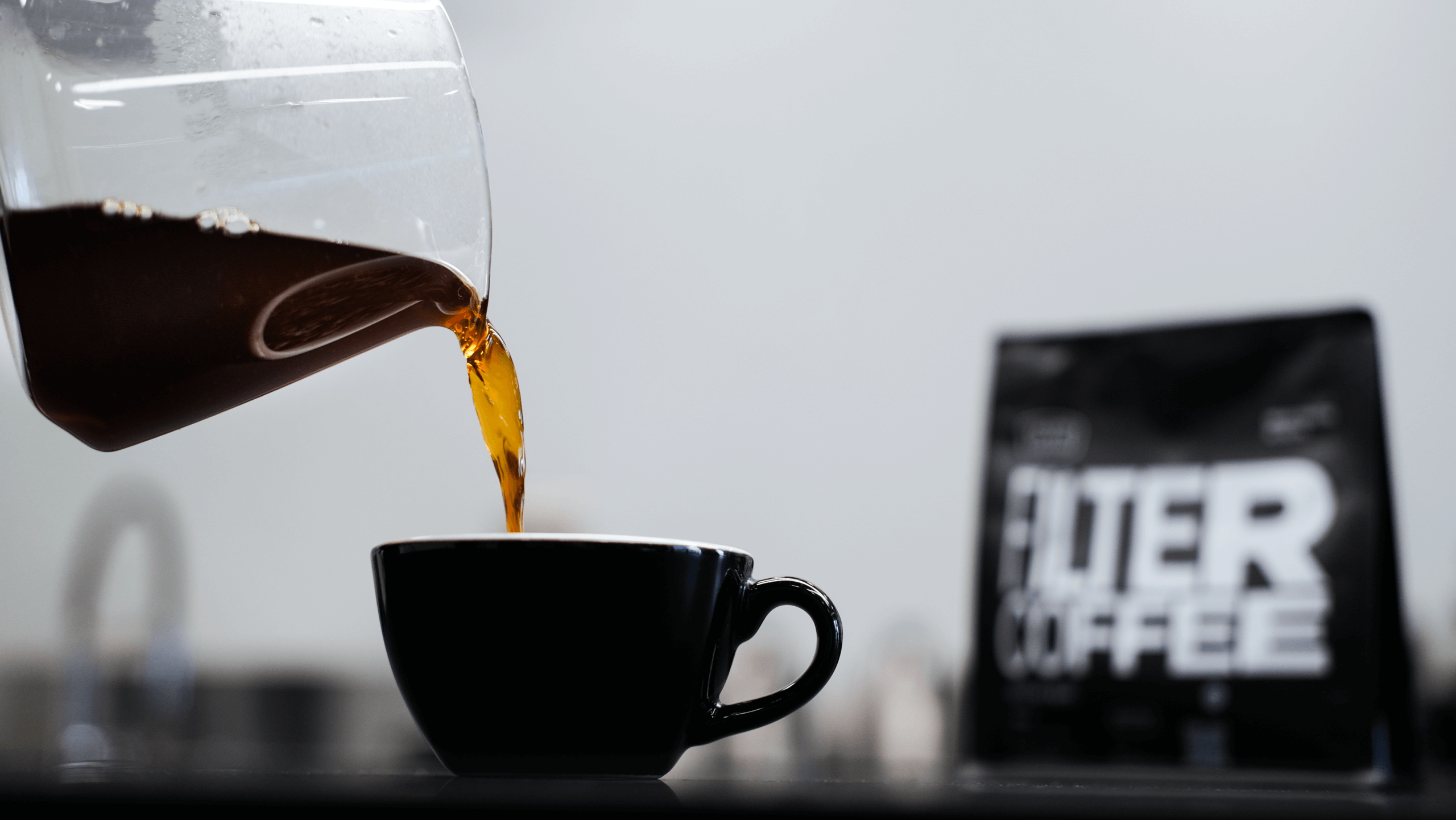 Чёрый кофе наливают в чашку из сёрвера